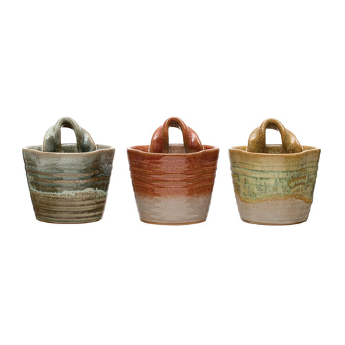 Three colors of stoneware wall planter with reactive glaze.