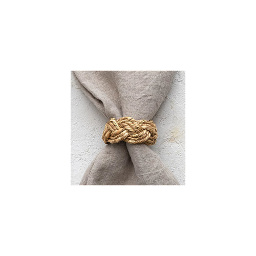 Close up view of the braided seagrass napkin ring around a napkin.