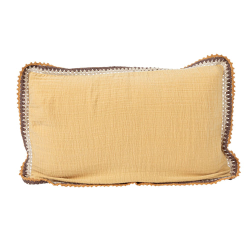Mustard yellow colored lumbar pillow with crotcheted edge