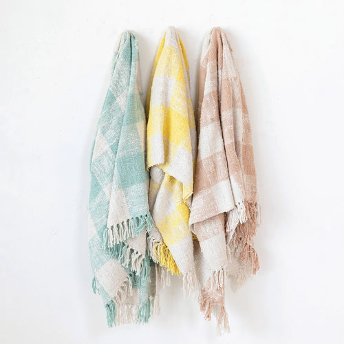 Hand woven cotton throw with fringe in blue, yellow and pink.