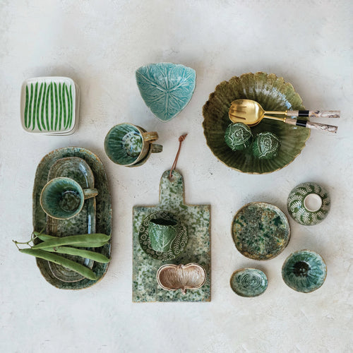Various embossed stoneware dishes with unique glazed finishes. 