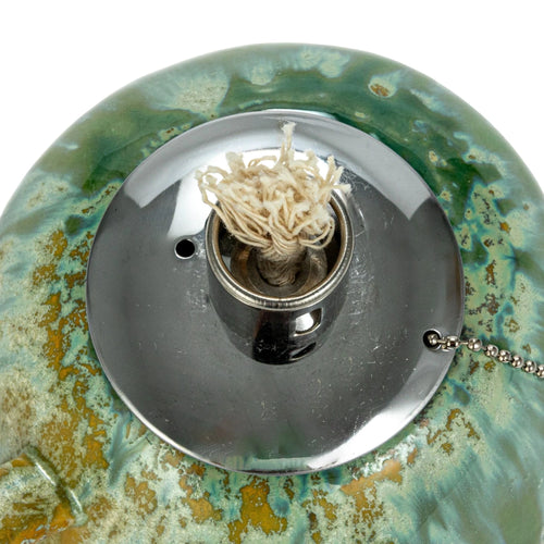 Close up view of the wick that comes in the metal insert of the stoneware oil lamp.