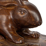 Close up view of the rabbits face on the stoneware baker with lid.