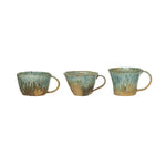 Glazed stonware mugs in various shapes.