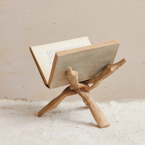 Reclaimed vintage wooden book stand holding a book.