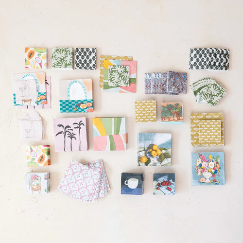 An assortment of different printed paper napkins.