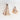 Four carved beech wood measuring spoons styled with some powdered spices. 
