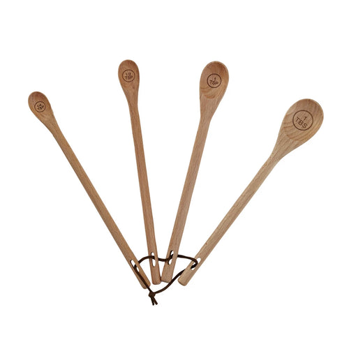 Set of four carved beech wood measuring spoons.