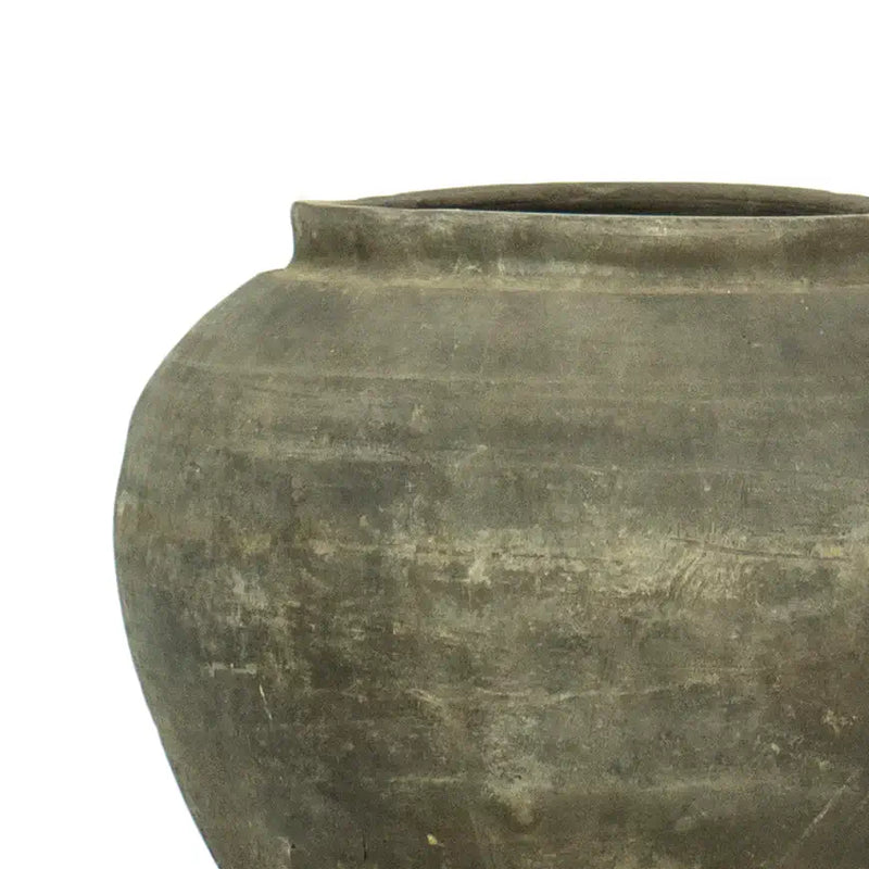 Texturized and worn black clay vase pot. 