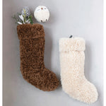 Two faux sherpa stockings in the colors brown and cream.