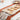 Wooden cutting board with baked items on a tablecloth