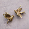Resin dove ornaments with a golden finish. Comes in two different styles.