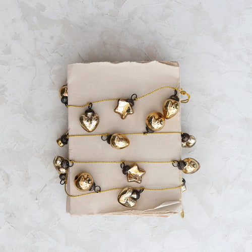 Vintage inspired mercury glass garland in gold finish. 