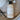 Baby wash bottle labeled 'Beauty from Bees' on a wooden surface with lavender and vanilla elements.