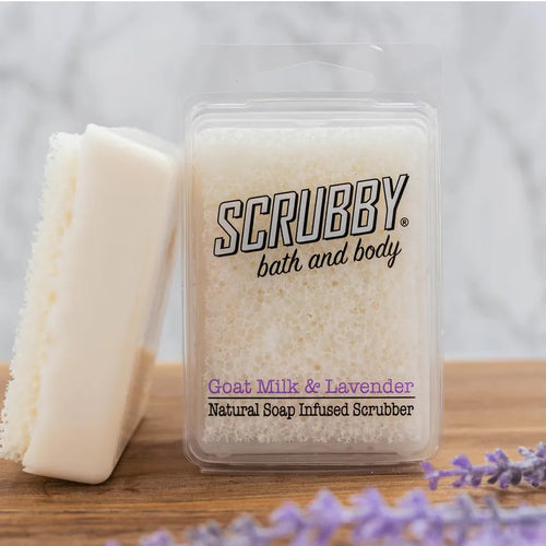 Goat Mile and Lavender Scrubby Soap on table with fresh lavender sprigs. 