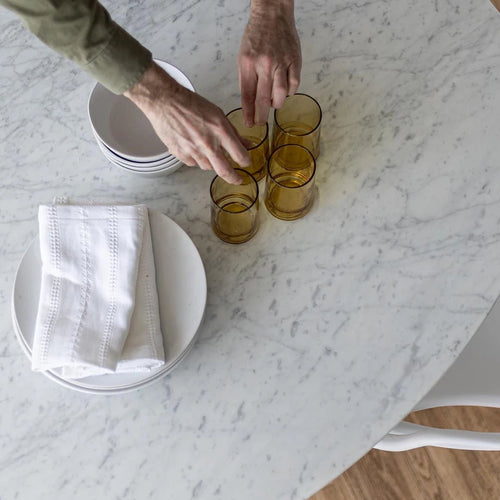 Birds eye view of the round flute Carrara marble dining tabletop. 