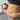 Person holding a candle and a bowl, with a focus on their belly.
