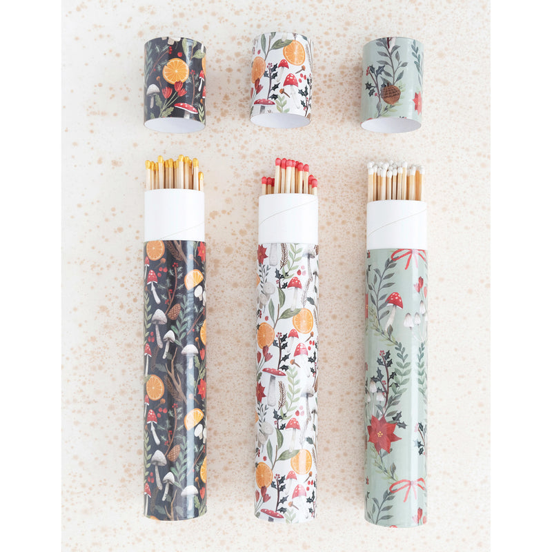 Matchbox tubes with holiday foliage designs in three different styles.