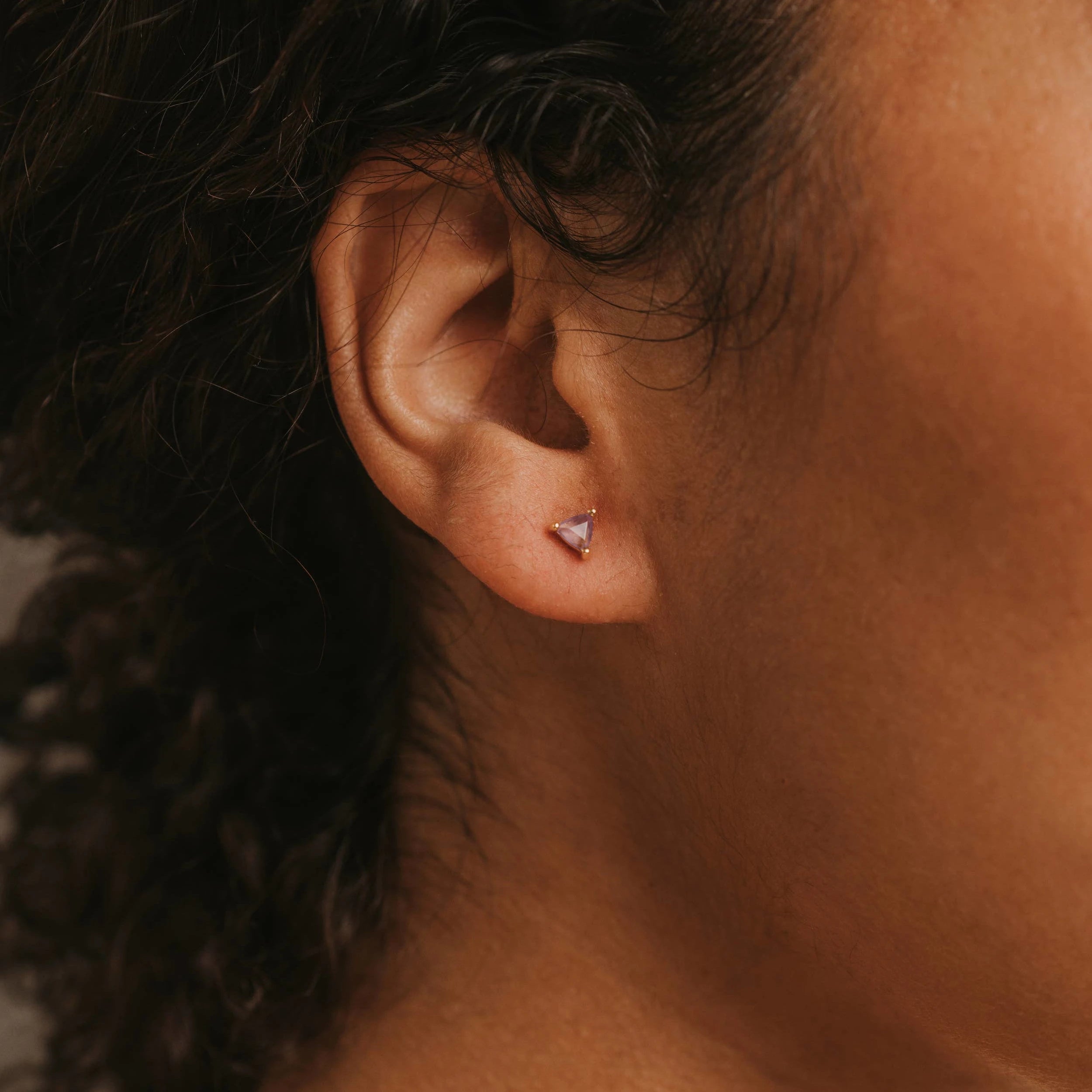 Model wearing the mini amethyst energy gem earring.