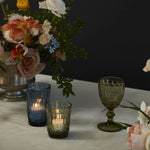 Vintage inspired glassware with tealight candles on a tablescape at wedding.