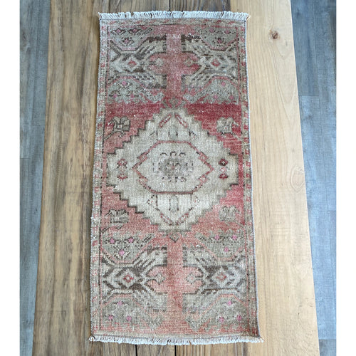 Turkish area rug in Dark and pale pinks, beige with dark brown accents.