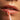 Close-up of a person applying lip serum with a brush