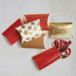 Red, white and gold envelope style gift boxes with small gifts inside. 