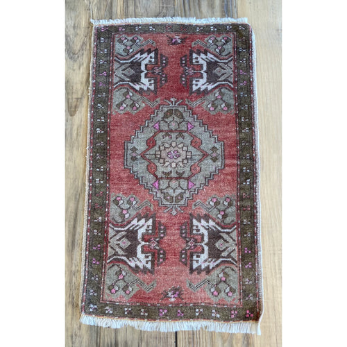 Handmade Turkish area rug with a deep, rich red colour and hints of pink.