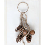 Natural door hanger with pinecones, jingle bells and jute rope. 