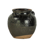 Texturized clay pot with black glaze. 