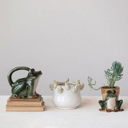 Stoneware frog planter pictured with various stoneware frog shaped items.