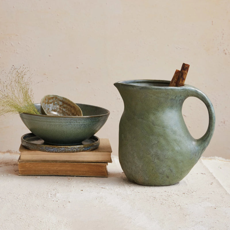 2-1/2 Quart Stoneware Pitcher and matching bowl stacked on vintage books.