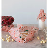 Powdered sugar dusted cookies wrapped in a candy cane beeswax food wrap.