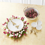 Tulip wreath placed underneath a serving platter on tablescape. 