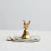 Brass Bell with Turkey on top of loose paper. 
