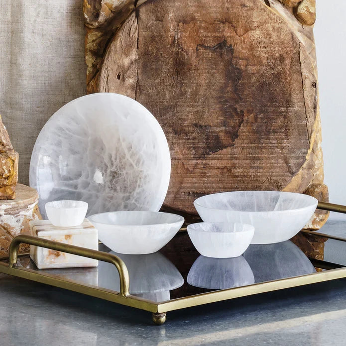 Selenite Bowls in various sizes styled on a brass tray. 