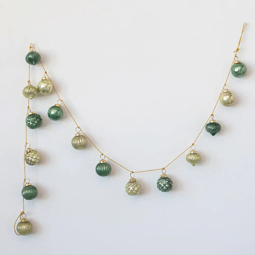Vintage green glass ball ornament with gold string. 