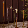 Single stem flowers and candles displayed in the Raywood Budvases on a table. 