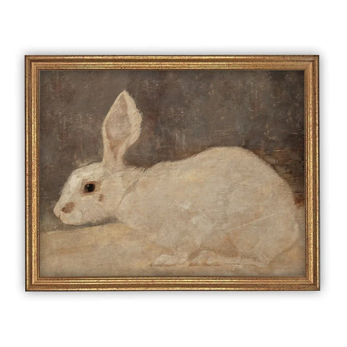 A vintage reproduction print of a rabbit on canvas in an antique gold frame. 